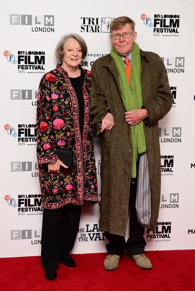 a man and a woman are standing on a red carpet at the bfi london film festival