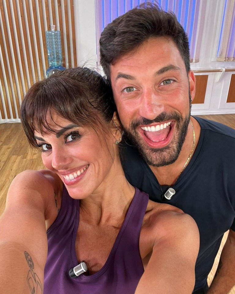a man and a woman are posing for a picture and smiling