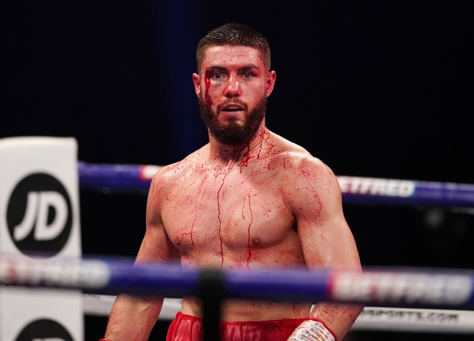 a man in a boxing ring with a jd sign in the background