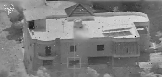 an aerial view of a large house with a helicopter flying over it .