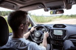 a man is driving a car with a navigation system