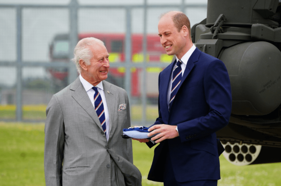 a man in a suit and tie stands next to another man in a suit and tie