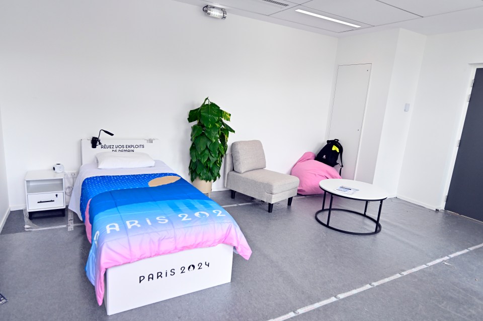a bedroom with a bed that says paris 2024 on it