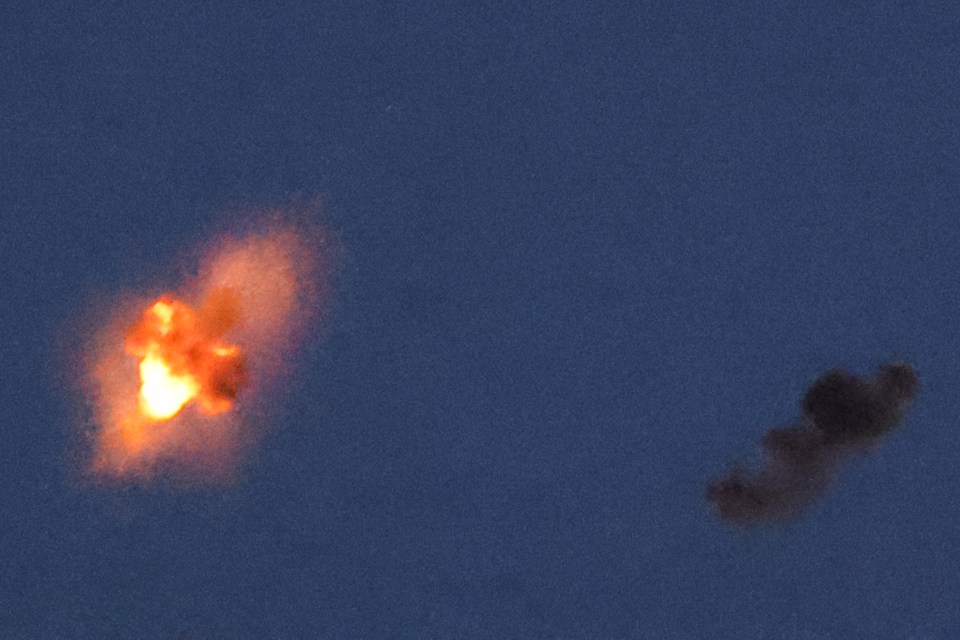 two explosions are visible in a dark blue sky