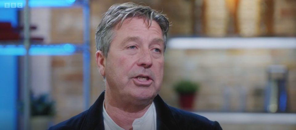 a close up of a man 's face with the bbc logo in the corner