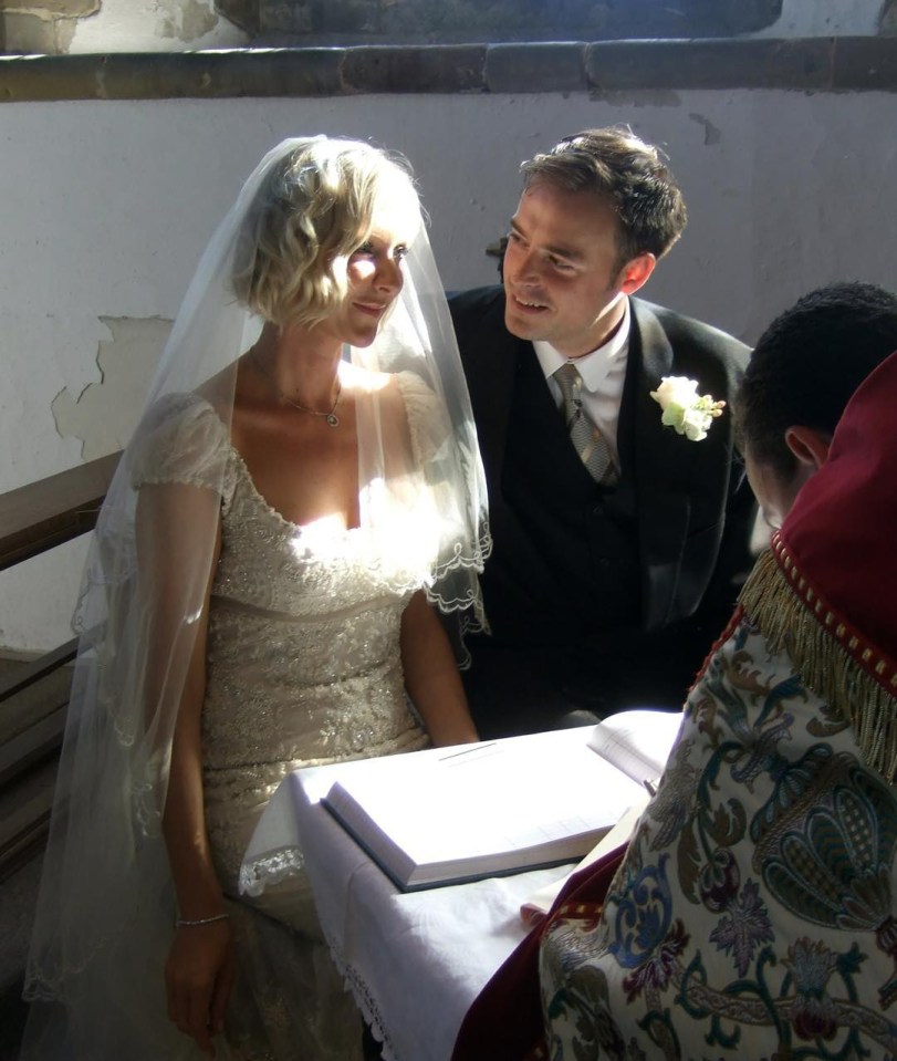 a bride and groom look at each other during their wedding ceremony