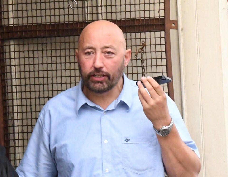 a bald man with a beard is wearing a blue shirt with the word eagle on it