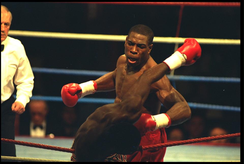 a man wearing red boxing gloves with the word reebok on them