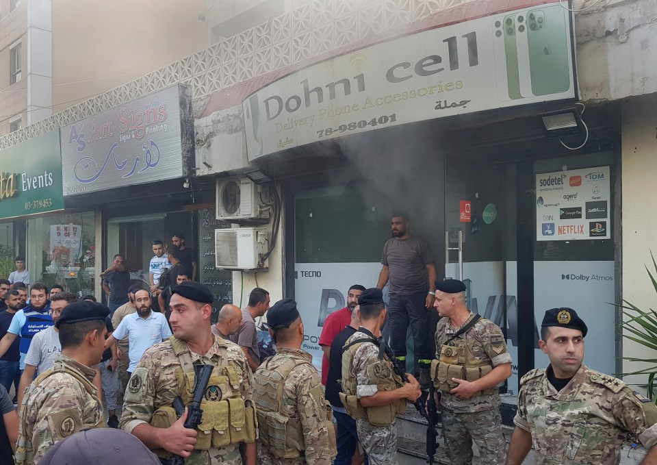 a group of soldiers stand in front of a store called dohni cell