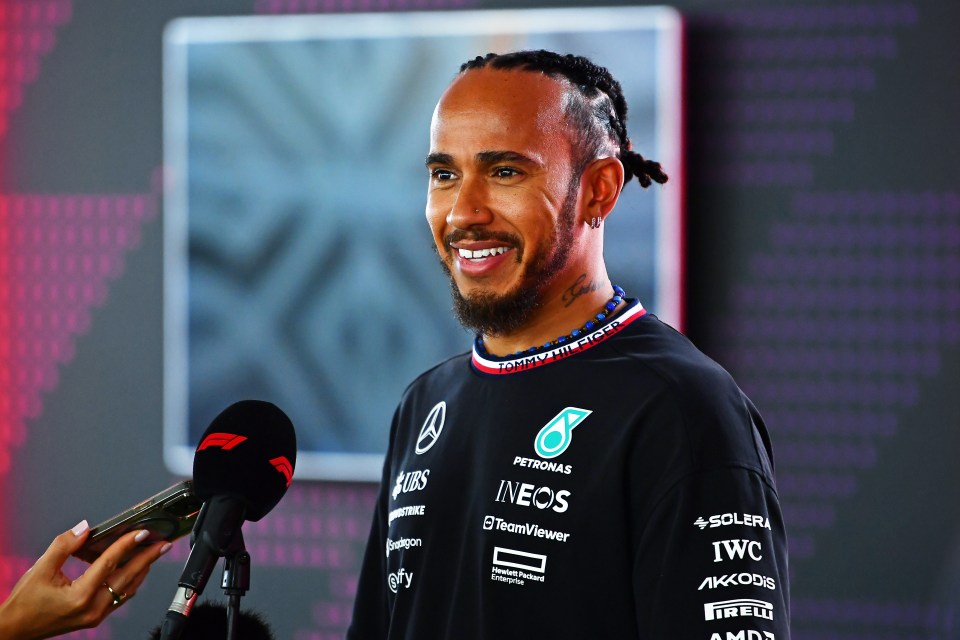 a man wearing a petronas shirt is being interviewed
