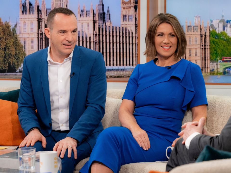 a man in a blue suit sits next to a woman in a blue dress