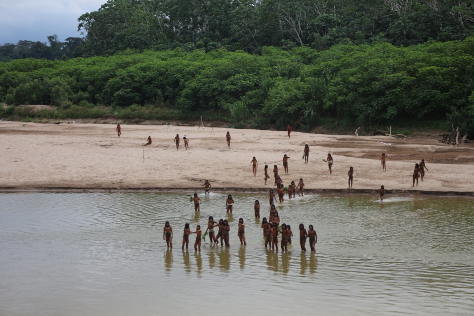 a group of people standing in a body of water