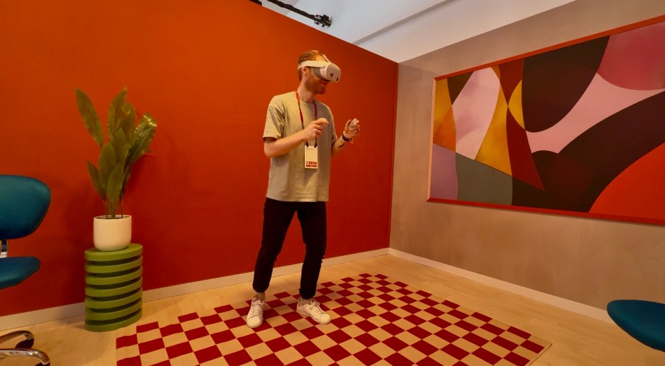 a man is wearing a virtual reality headset and holding a controller