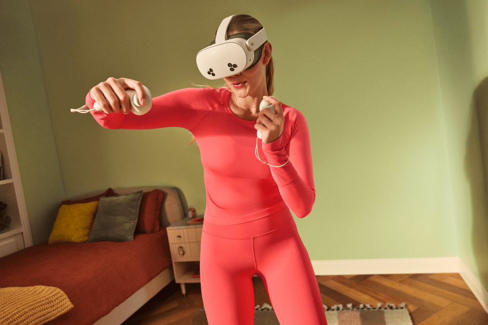 a woman wearing a virtual reality headset and holding a controller