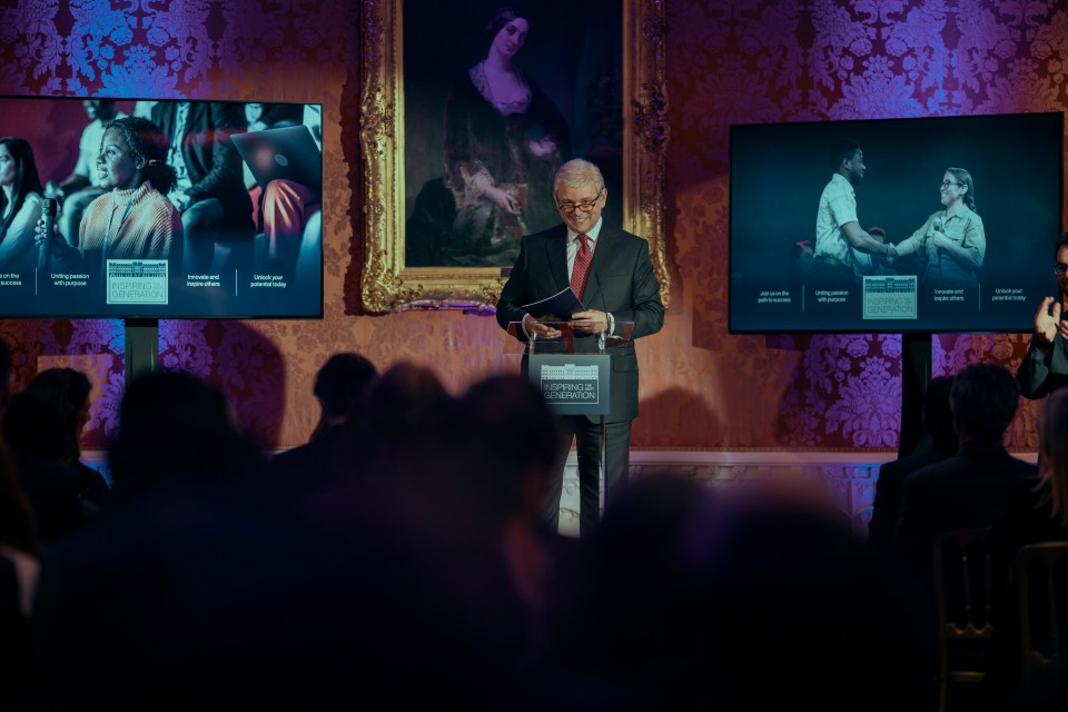 a man stands at a podium with a sign that says conference centre