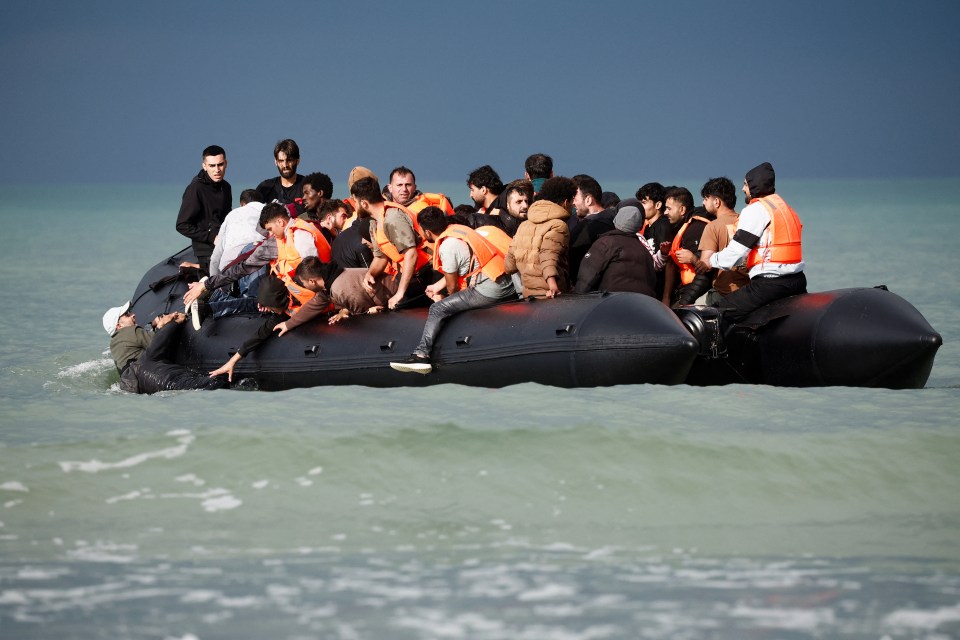 a large group of people are in a boat in the ocean