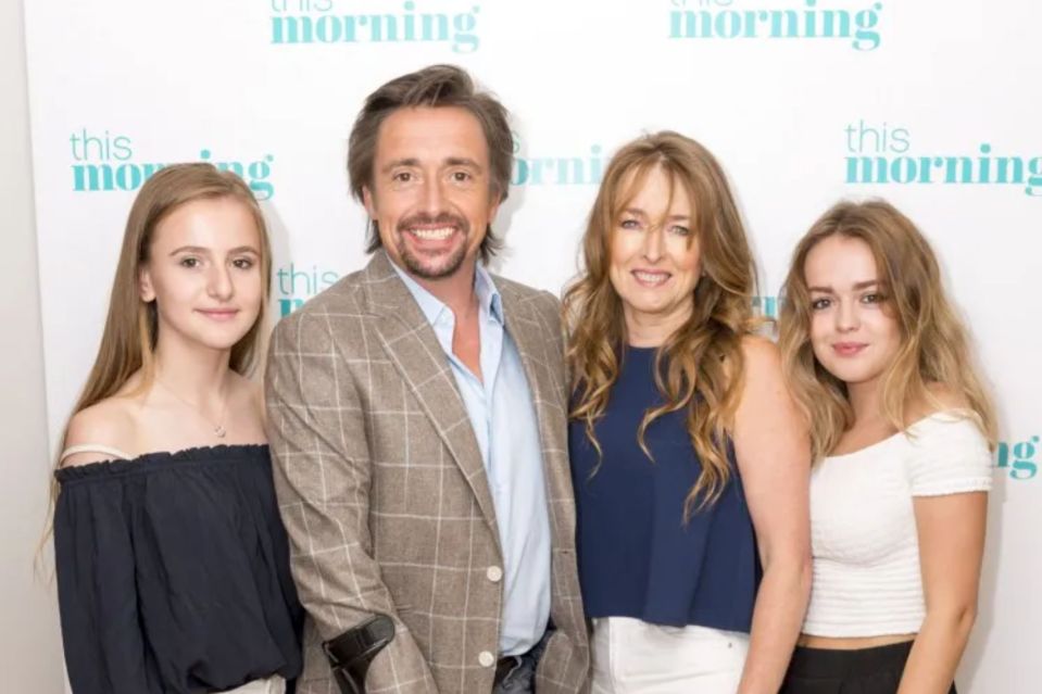 a family poses for a picture in front of a wall that says this morning