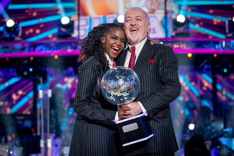 a man and woman holding a trophy that says ' dancing with the stars ' on it