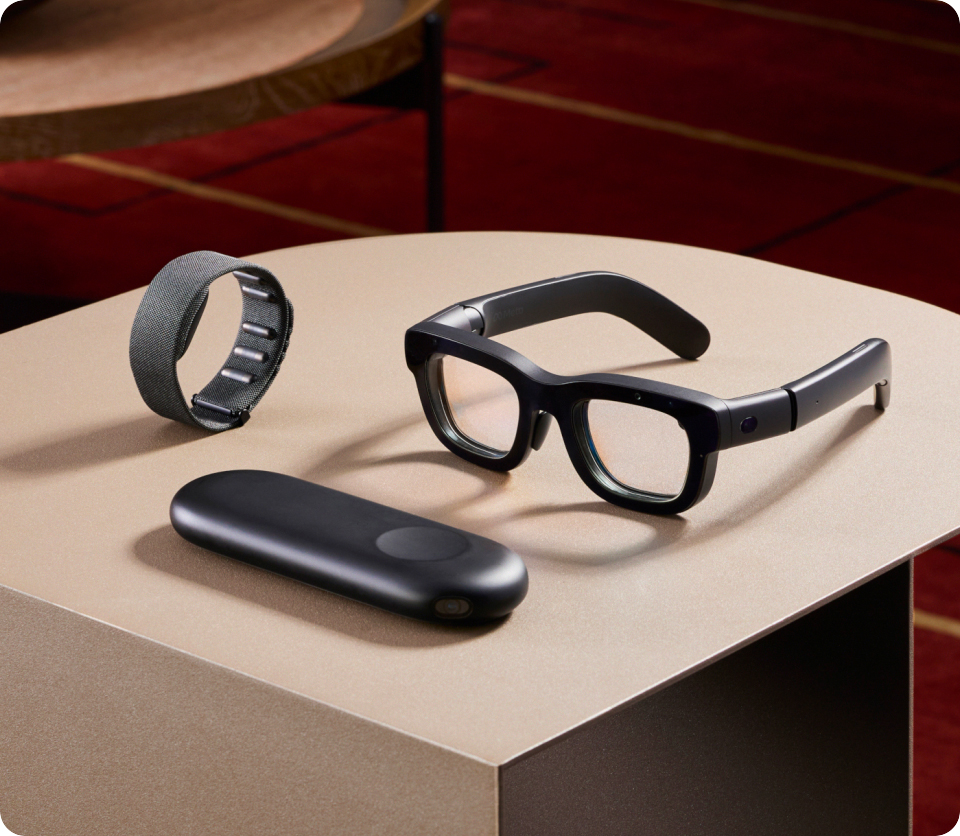 a pair of glasses a watch and a charger on a table