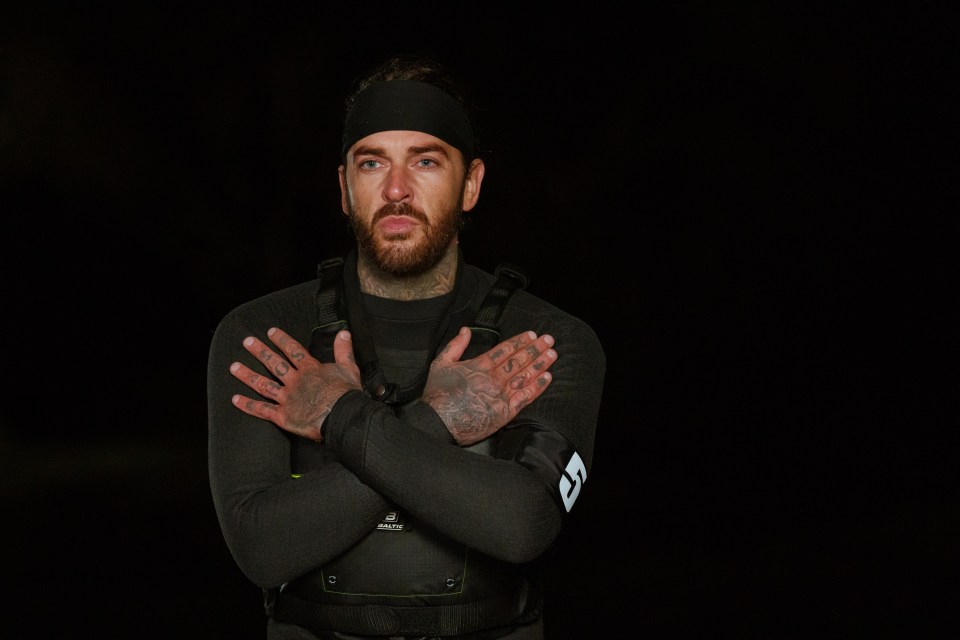 a man in a wetsuit has a black headband on his head