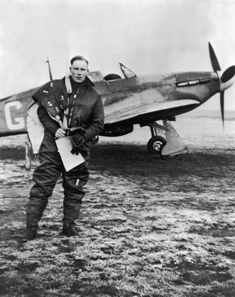 a man stands in front of a plane with the letter g on it