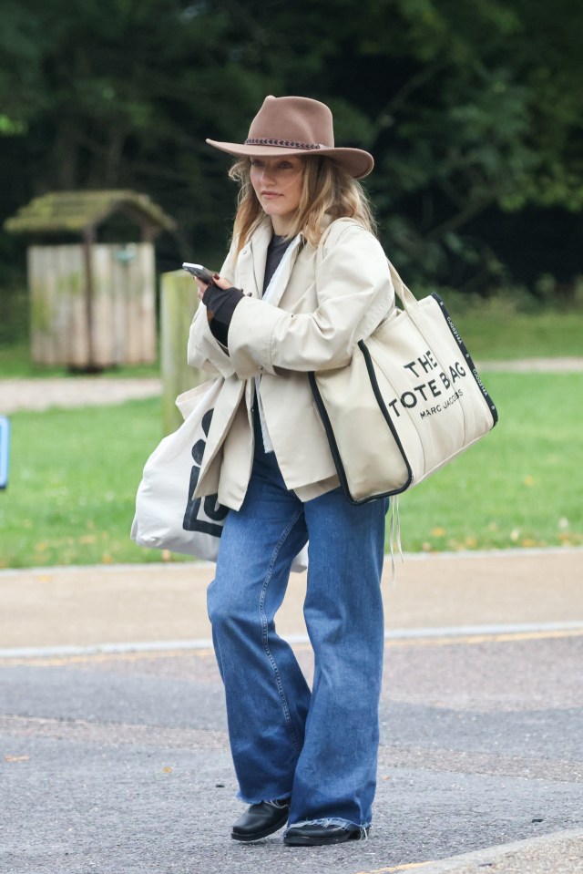a woman carrying a tote bag by marc jacobs