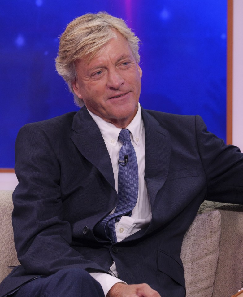 a man in a suit and tie is sitting in a chair
