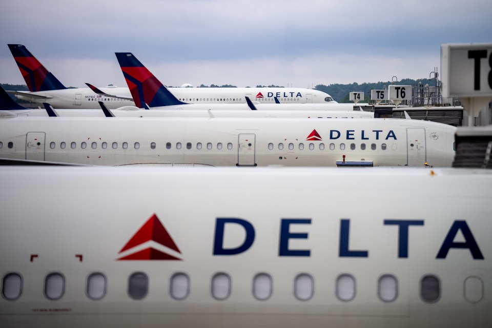 a row of delta airlines planes are parked on the tarmac