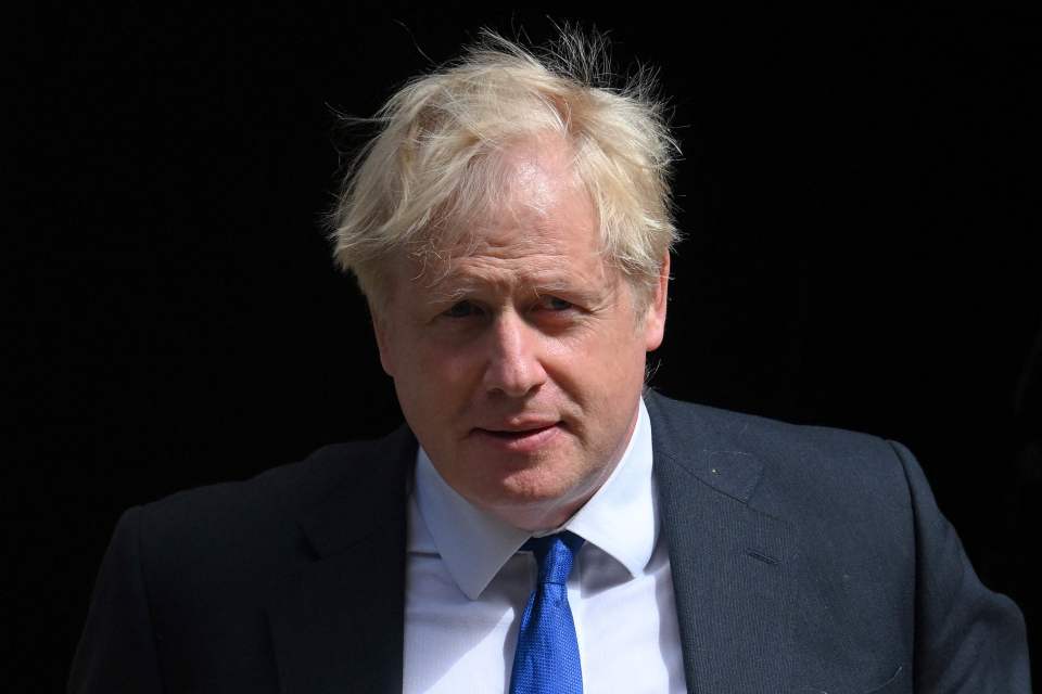 a man with blonde hair wearing a suit and tie