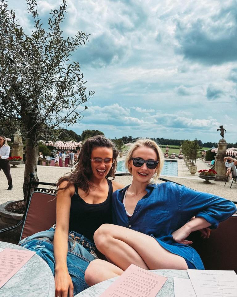 two women sit at a table with a menu on it