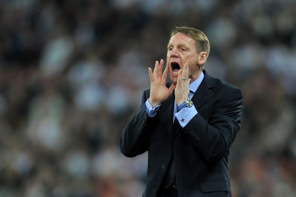 a man in a suit is shouting with his mouth open