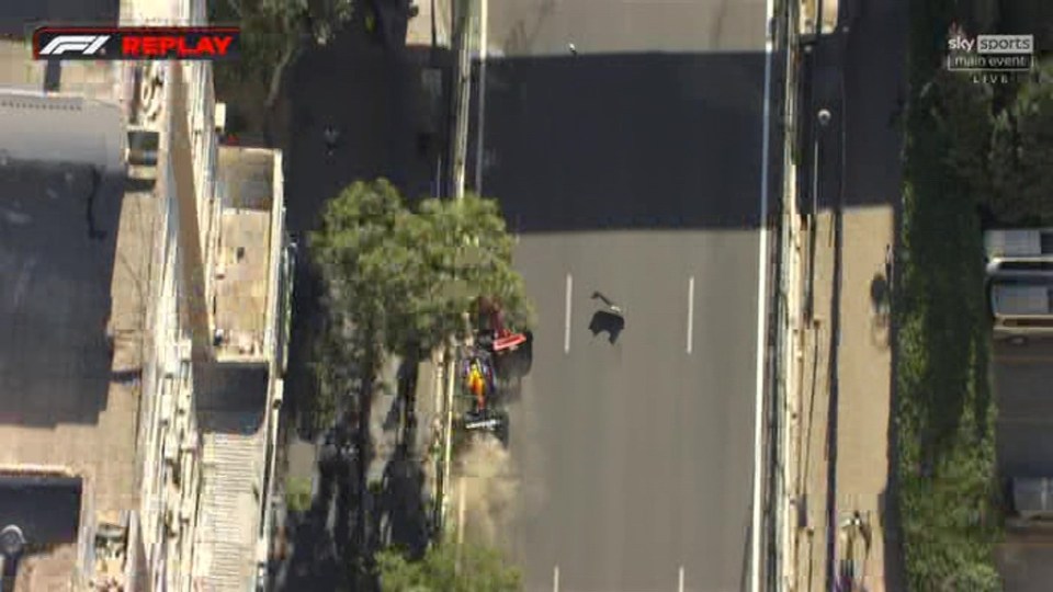 an aerial view of a race car driving down a street .