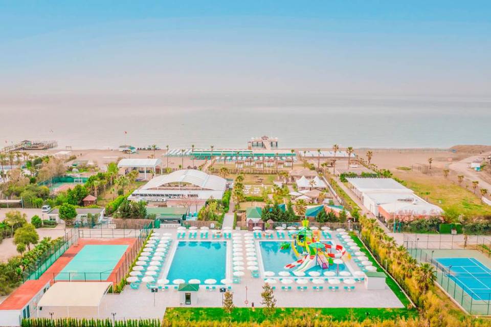 an aerial view of a resort with a large swimming pool