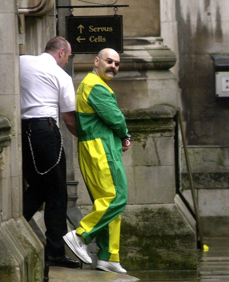 a man in a green and yellow jumpsuit is being escorted by a police officer