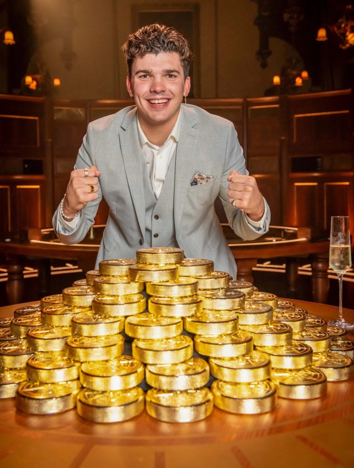 a man in a suit stands in front of a pile of gold coins