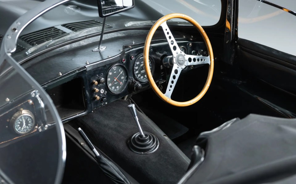 a black car with a steering wheel that says jaguar on it