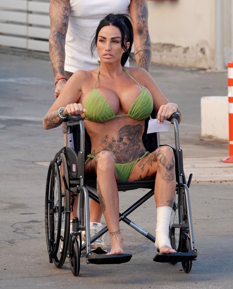 a woman in a green bikini sits in a wheelchair