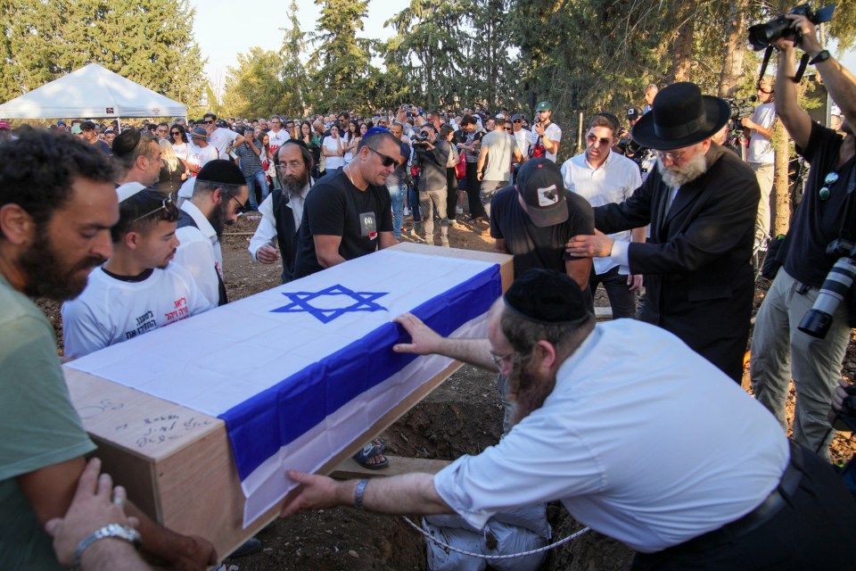 a group of men carrying a coffin with a star of david on it