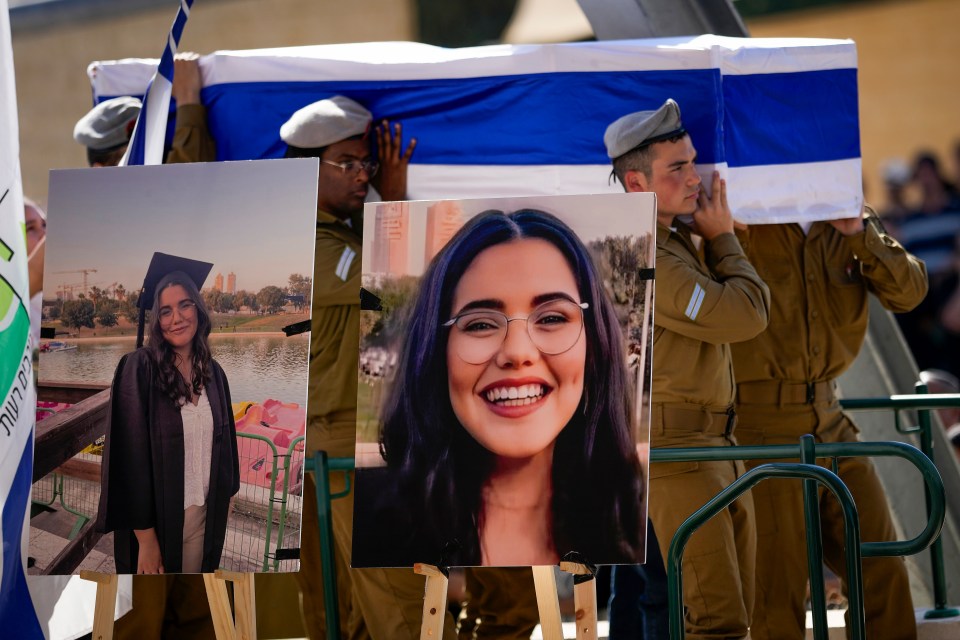 a group of soldiers holding a flag and a picture of a woman