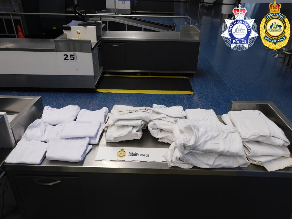a stack of white sheets on a table with a sign that says border force
