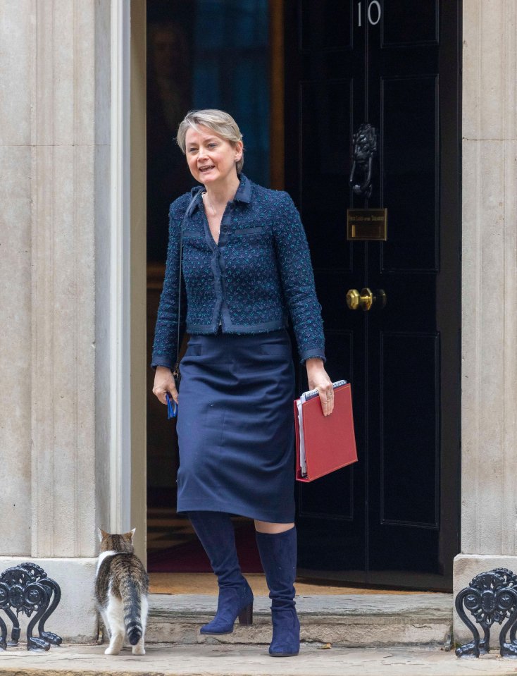 a woman in a blue skirt is standing in front of a door with the number 10 on it