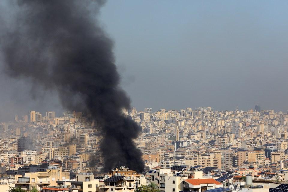 smoke coming out of a building in a city