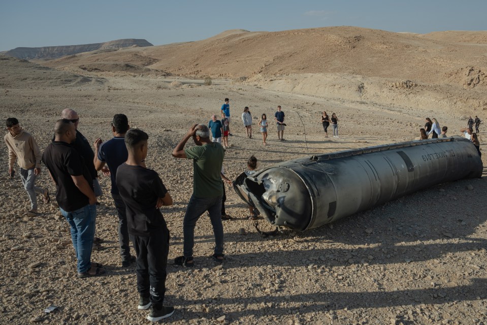 a group of people are standing around a large cylinder that says ' eot ' on it