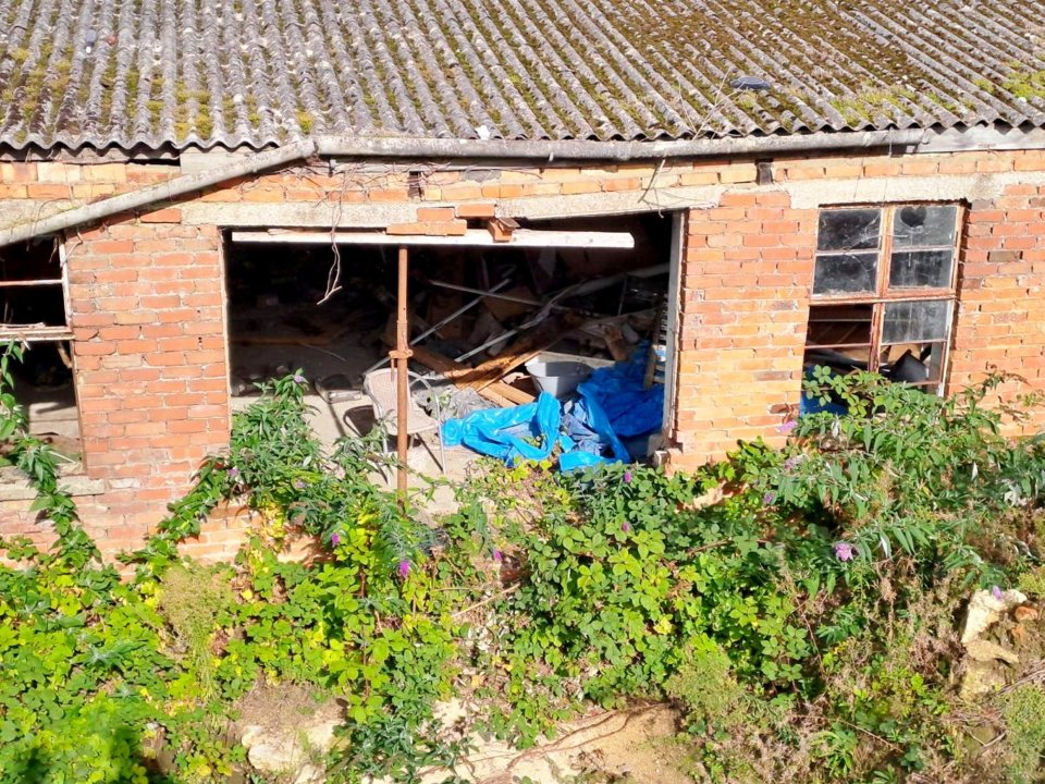 a brick building with a blue tarp in front of it
