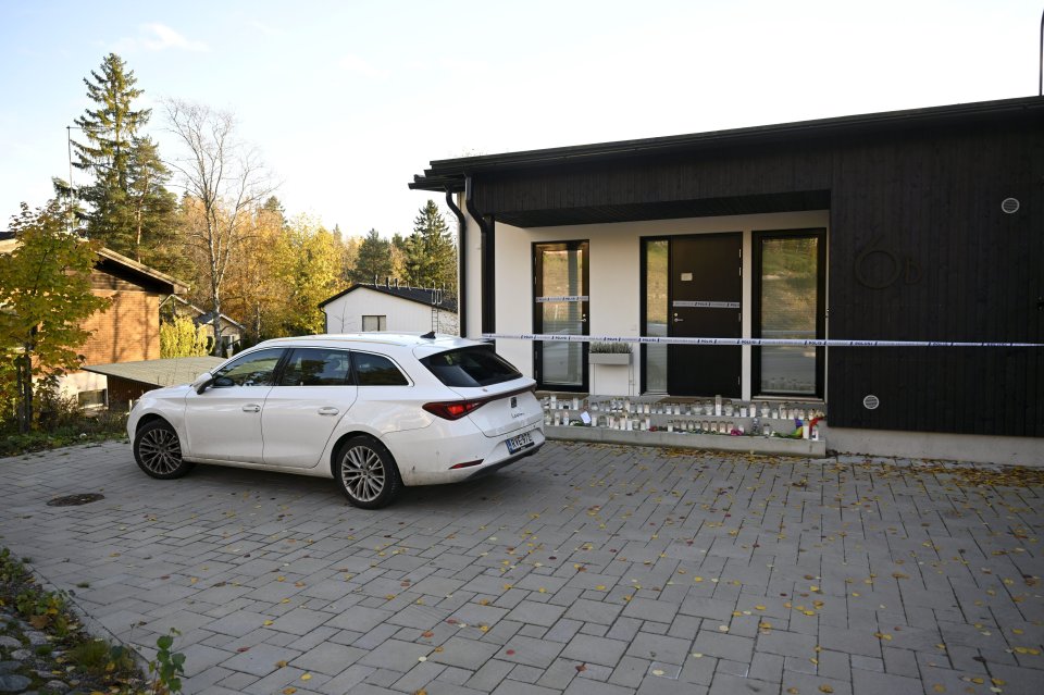 a white car is parked in front of a house