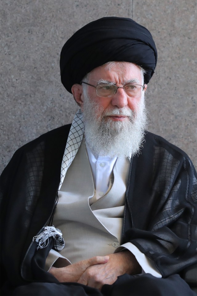a man with a beard wearing glasses and a black turban