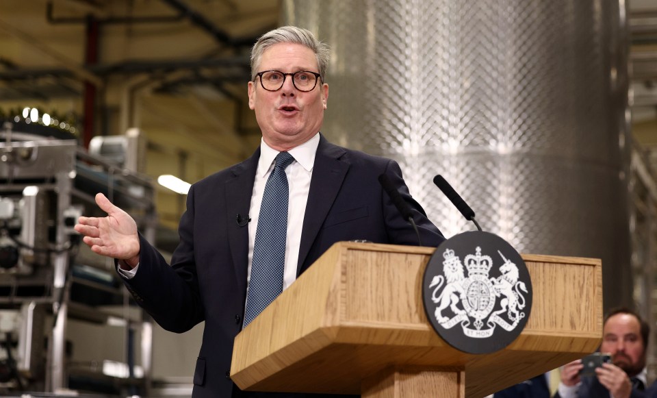 a man stands at a podium with a coat of arms on it