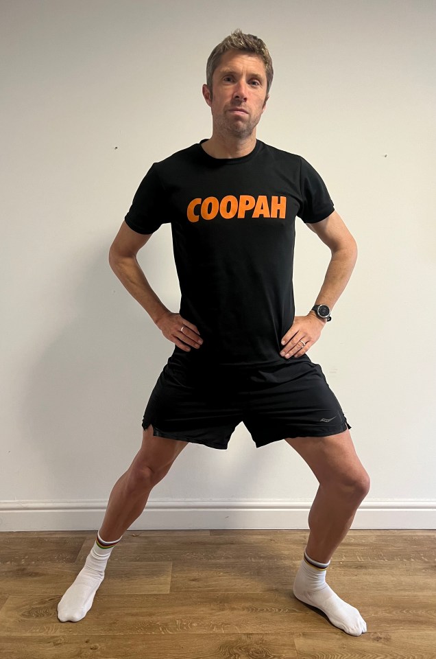 a man wearing a black shirt that says coopah