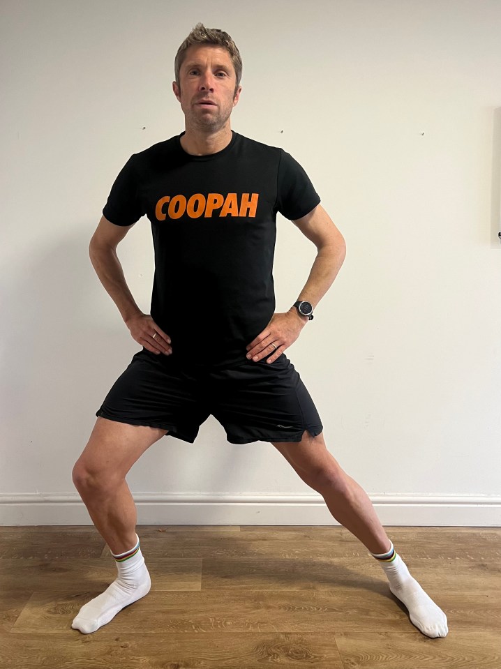 a man wearing a black shirt that says coopah on it