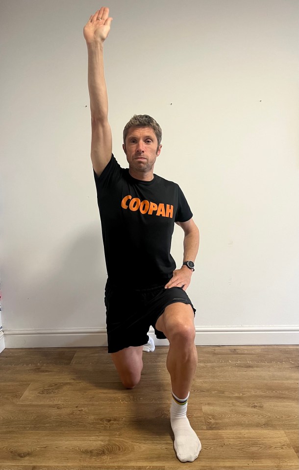 a man wearing a black shirt that says coopah on it
